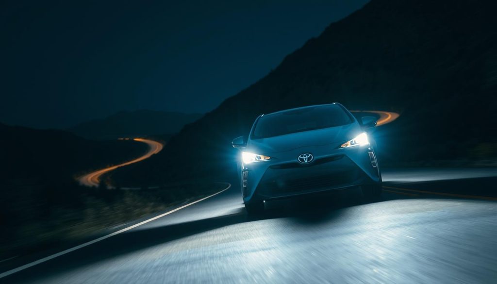 Toyota Prius with upgraded LED headlights illuminating a mountain road at night Toyota Prius with upgraded LED headlights illuminating a mountain road at night